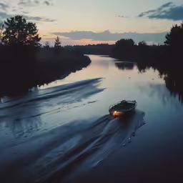 a large boat traveling down a river at dusk