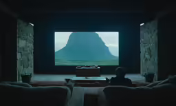 someone watching a mountain show on the television screen