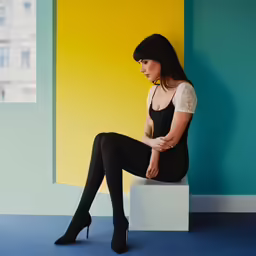 the woman is wearing high heel boots posing for the camera