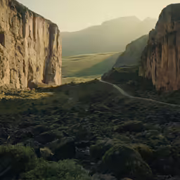 there is a mountain near a road with rocks on it