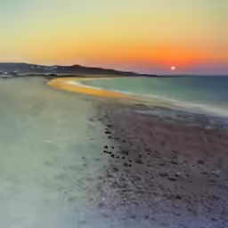 the sunset is reflecting off the beach