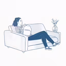 the woman is sitting on her sofa with boxes in front of her