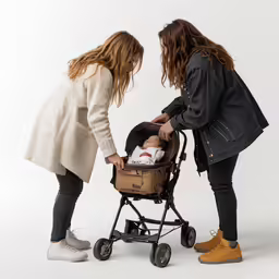 the two women are pushing the baby in the stroller