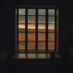 a window with a view of the plains outside
