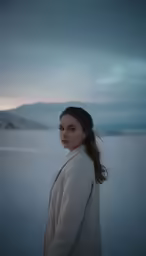 a woman in an image wearing a coat on a cloudy day