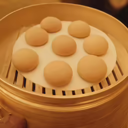 the wooden steamer has ten small round cookies on it