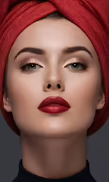 a woman wearing red make up and a turban