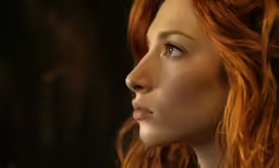 an artistic photo of a woman with red hair and piercings