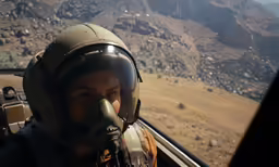 the man is sitting in a helicopter with his face pressed through the window