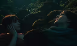 a woman laying down with her hands on her face