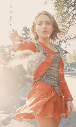 a woman standing in the dirt with a hand held up