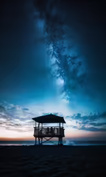 a tree house sits under the stars above the ocean