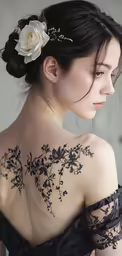 a woman with black and white tattoos on her back