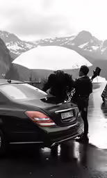 the mercedes is driving on a wet road