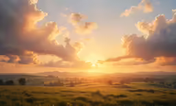 the sun is setting over the hills and trees