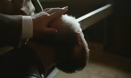 man with his head pressed on the back of his hands