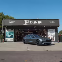a gray acura parked in front of a building