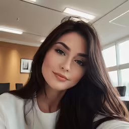 an asian woman with long dark hair and a large open window is looking at the camera