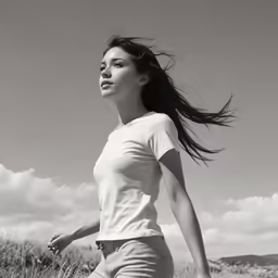 black and white photograph of a girl on a field