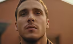 a man with his eyes open in front of the camera
