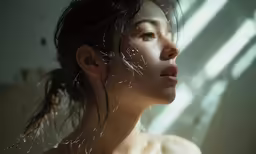 a woman is looking away with her hair in the wind