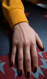 a close up photo of a hand that is resting on a star pattern