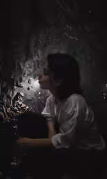 a woman with her eyes closed and staring into the dark