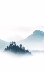 fog hangs in the air over a small island
