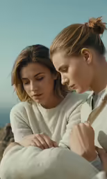 two beautiful young women standing close together