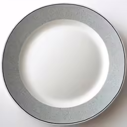 the edge of a gray and white plate