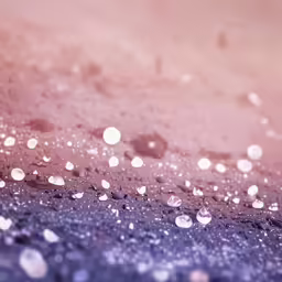 a blurry photo with many drops of rain on the asphalt