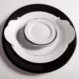 a black plate and white plate sit on top of each other