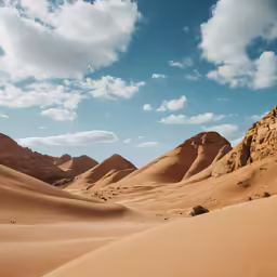 some desert dirt hills and clouds in the sky