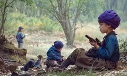 three little boys playing with toy trains in the woods