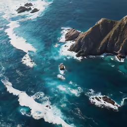 an aerial view of water flowing into some rocky shoreline