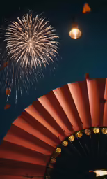 fireworks are shown over an orange fan at the same time