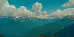 large mountains covered in snow under a blue sky