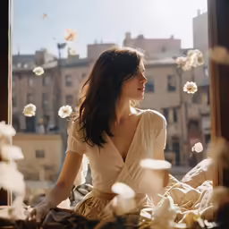a woman sitting on the windowsill in the room