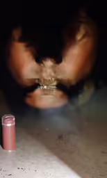 a woman with her mouth open with lipstick on the table