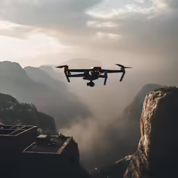 a small plane flying over a gorge and mountains