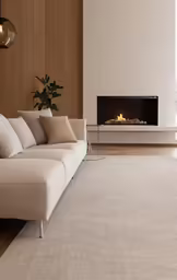 this modern living room has a white couch and fireplace in it