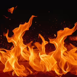 flames glowing brightly and red as it rises