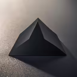 a triangle made from black material sitting on top of a counter