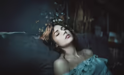 a beautiful young woman with her eyes closed in a dark room