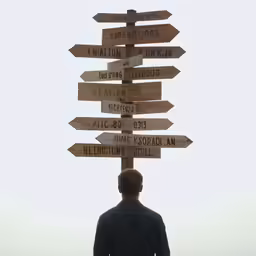 man standing in front of multiple wooden signs