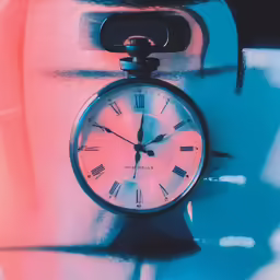 clock between two fingers with two colored shapes