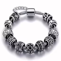 a silver bracelet with different sized beads,an open charm bracelet with a heart design