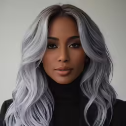 grey haired model wearing a dark turtle neck sweater