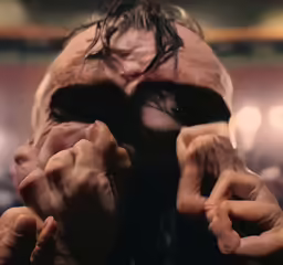 the movie poster features an image of a man in black with his hands covering his face