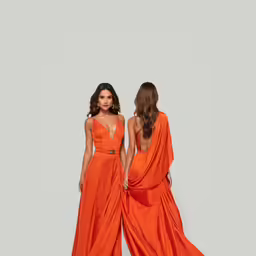two women wearing dresses standing together with one another